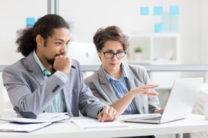 Two people analyzing planing and results
